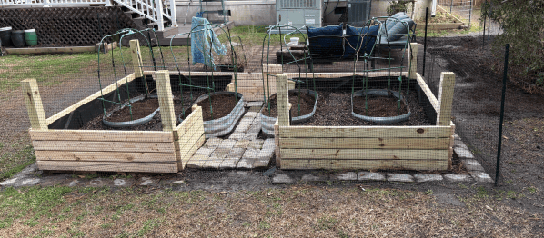 Two freshly built cedar raised beds set in place